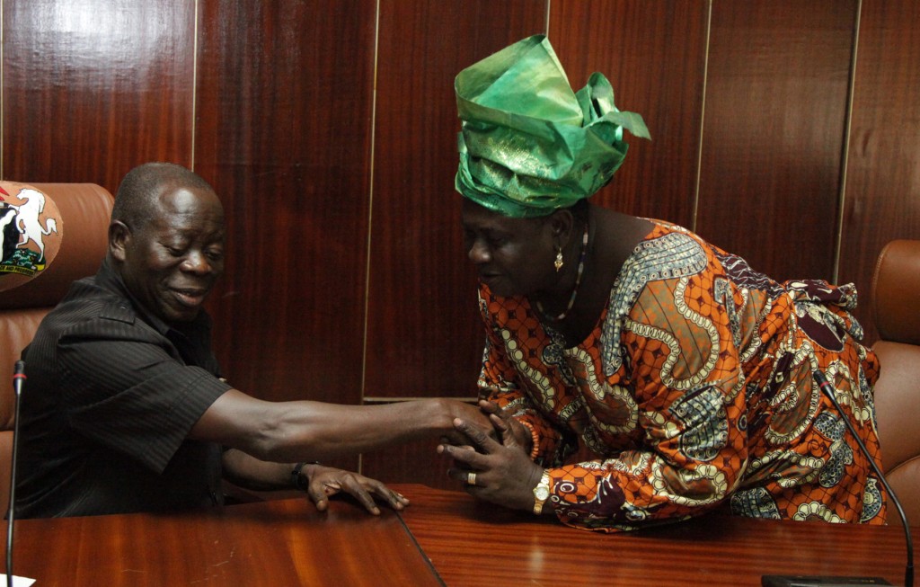 Governor Adams Oshiomhole of Edo State and Mrs Blacky Omoregie, market women leader, Edo State during a sensitisation meeting with market women on Ebola Virus at the Government House, yesterday, (Monday).