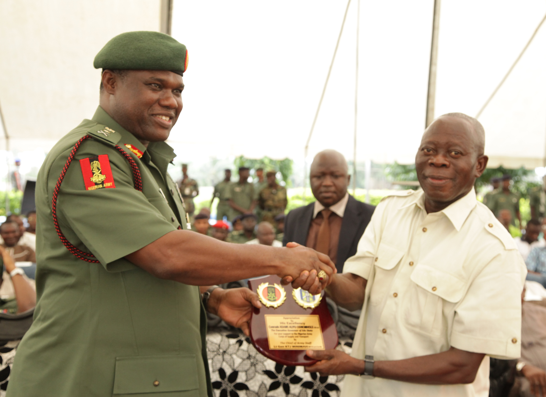 The Chief of Army Staff, Lt-General Kenneth Minimah presents a plaque to Governor Adams Oshiomhole of Edo State during the commissioning of the remodeled Officers' Mess of the Nigerian Army School of Supply and Transport, Benin City, last Friday.