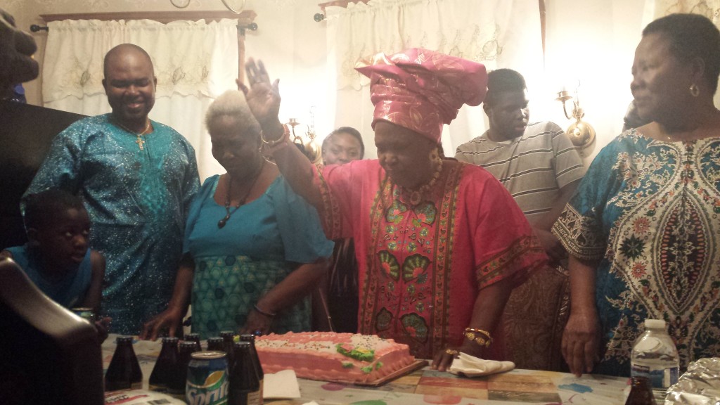 Madam Omorotionmwan lifts up her right hand to praise God during prayer.