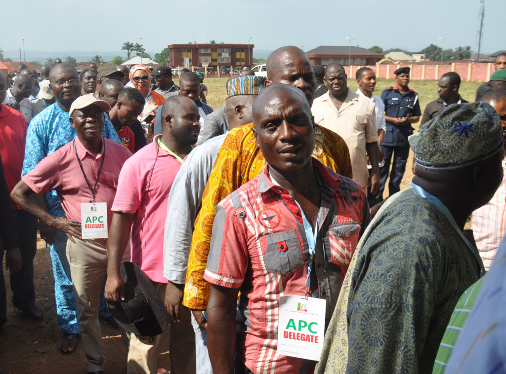 Governor Adams Oshiomhole of Edo State (in cap) queues up to vote as a delegate in the All Progressives Congress House of Assembly primaries at the Azama Primary School, Jattu, Etsako West Local Government Area, on Tuesday. Alltimepost.com