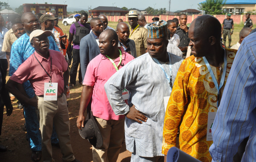 Governor Adams Oshiomhole of Edo State (in cap) queues up to vote as a delegate in the All Progressives Congress House of Assembly primaries at the Azama Primary School, Jattu, Etsako West Local Government Area, on Tuesday. Alltimepost.com