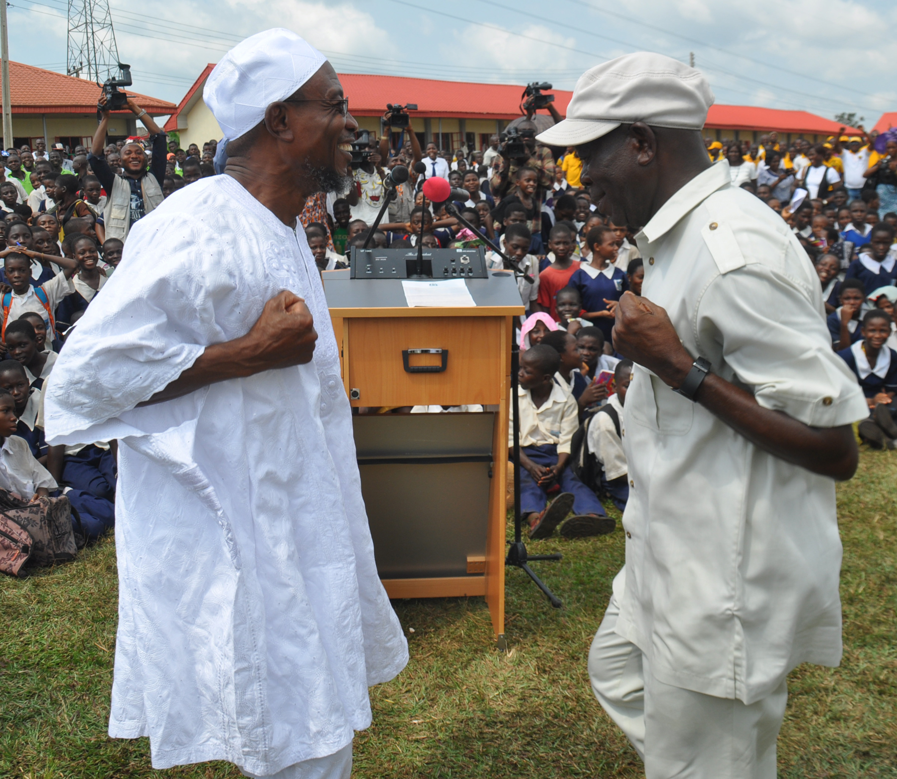 Ogbeni Rauf Aregbesola, Governor State of Osun and Comrade Adams Oshiomhole, Governor of Edo State dance during the commissioning of the rebuilt Asoro Grammar School in Benin City, on Friday