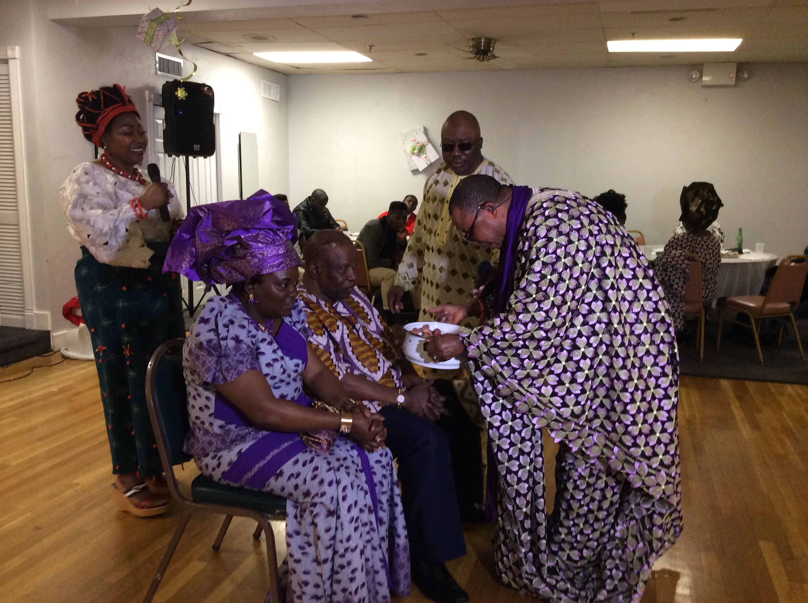 Photo shows Adams Aliu Otokiti, Secretary-General, Benin Club of Massachusetts performing the ceremony of prayer, thanksgiving and blessing at the Igue Festival in Boston. Seated are Mr. and Mrs. Udinyiwe Idahosa, receiving the anointing while Mrs. Bridget Ekhator and Mr. Ben Osasu Emovon look on. Photo, By Alltimepost.com