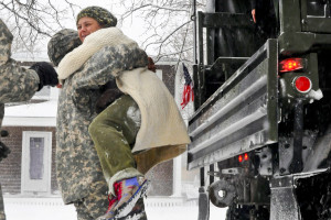 Army National Guard Spc. Jian Barcelo helps a stranded resident out of a military truck in Scituate, Mass., Jan. 27, 2015. Barcelo is a truck driver assigned to the Massachusetts National Guard's 1058th Transportation Company. The soldiers were called to duty to support local and state agencies during the response to Winter Storm Juno.