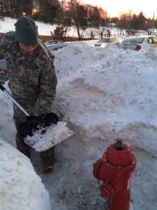 Army Staff Sgt. Jon Bohannon, a dispersing manager with the Massachusetts Army National Guard's 101st Finance Detachment, clears snow from a fire hydrant in West Newton, Mass., Feb. 10, 2015. Massachusetts National Guard soldiers and airmen were activated to augment the state's snow clearing  efforts after recent storms combined to dump more than 6 feet of snow in some areas. U.S. Army photo by Sgt. 1st Class Laura Berry