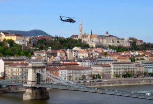 A UH-60 Black Hawk helicopter from the U.S. Army Europe's 12th Combat Aviation Brigade cruises over Budapest, Hungary, during Exercise Saker Falcon in April 2014. Defense Department officials have announced a restructuring of the brigade and subordinate units in Germany as part of the Army's Aviation Restructuring Initiative in Europe. U.S. Embassy Budapest. Photo by A. Reategui