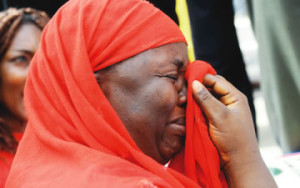 One-of-the-mothers-of-the-missing-Chibok-schoolgirls-wipes-her-tears