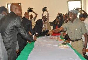 Governor Adams Oshiomhole congralutes Mr Lucky Wasa after being sworn in as a Permanent Secretary in the State Civil Service, yesterday