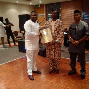  Mr. Lancelot Oduwa Imasuen (left) receives his award from Eghoba president, Mr. Ehigie Alile-Egbon, while the out-going Secretary-General of the organization, Mr. Osagie Igbinosun (right) looks on with rapt attention.
