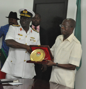 Rear Admiral Samuel Alade, Commandant, Natiional Defence College (left) presents a souvenir to Governor Adams Oshiomhole of Edo State during a visit of participants of the National Defence College, Course 24 to the Governor in his office, Friday.