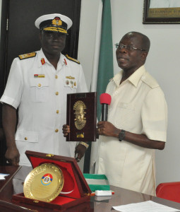Governor Adams Oshiomhole of Edo State (right) presents a souvenir to Rear Admiral Samuel Alade, Commandant, Natiional Defence College during a visit of participants of the National Defence College, Course 24 to the Governor in his office, Friday.