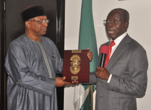 Governor Adams Oshiomhole of Edo State presents a souvenir to Dr Osagie Ehanire, Minister of State for Health, during the Minister's visit to the Governor in Benin City on Monday.