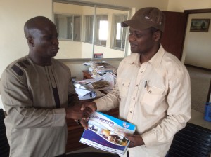 Rev. David Ugolor, ANEEJ Executive Director (left) presents CITIZEN REPORT CARD on Niger Delta Institutions and Edo State Budget analysis to Alltimepost.com Publisher, Comrade Emman Okuns.