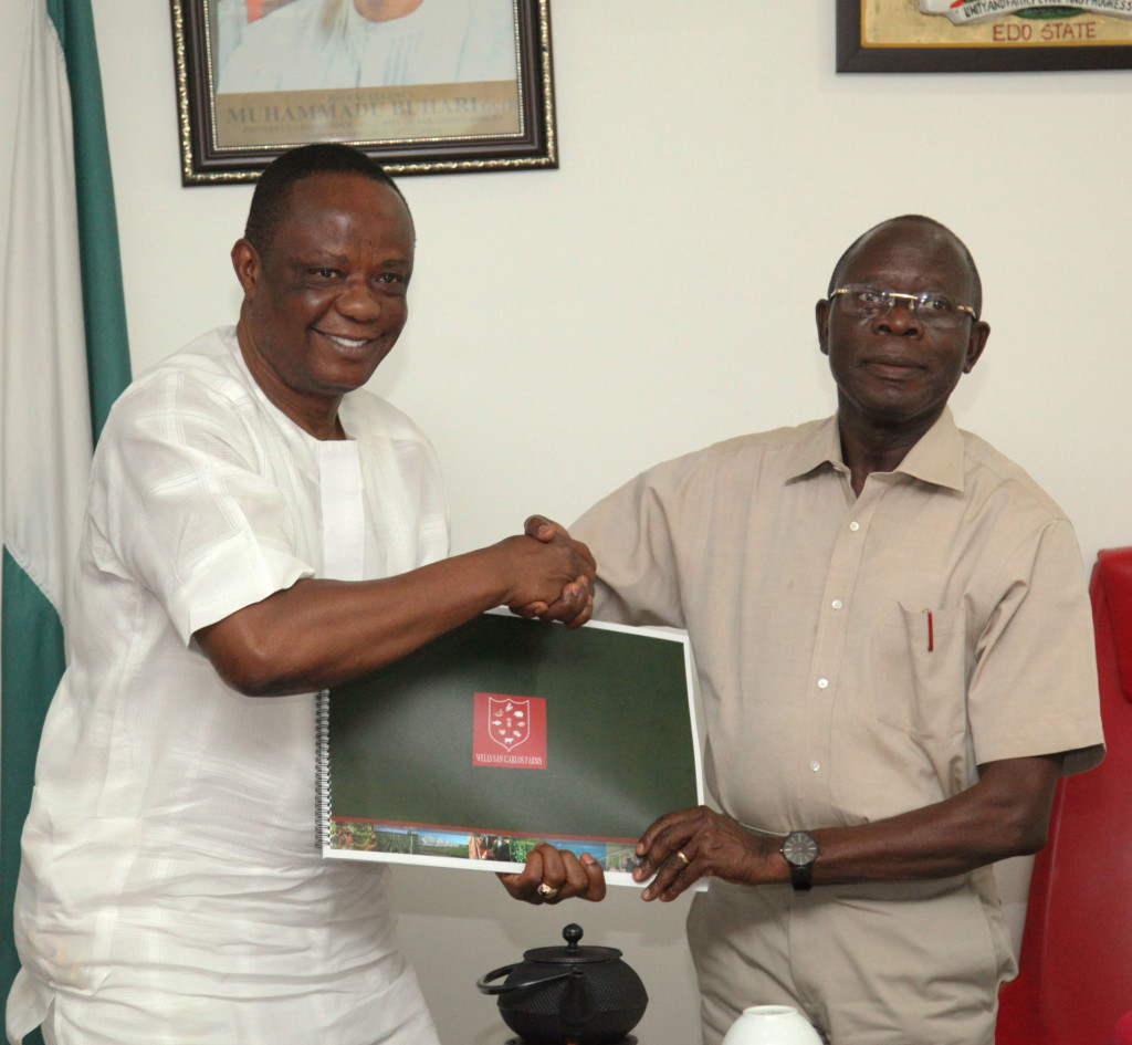 Capt Hosa Okunbo, Chairman, Wells Sam Carlos Farm presents a document to Governor Adams Oshiomhole at the presentation of the Agro business plan of Wells Sam Carlos Farm to the Governor on Tuesday.