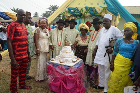 Mrs. Agnes Ugolor, flanked by her children, including Rev. David Ugolor and relatives as she cuts her birthday cake
