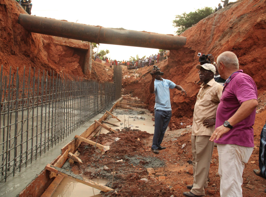 Governor Adams Oshiomhole of Edo State and Mr. Paulo Pistolesi, Area Manager, Hartland Nigeria Limited during the inspection of the underground drain at Upper Sokponba area of Benin City, Tuesday.