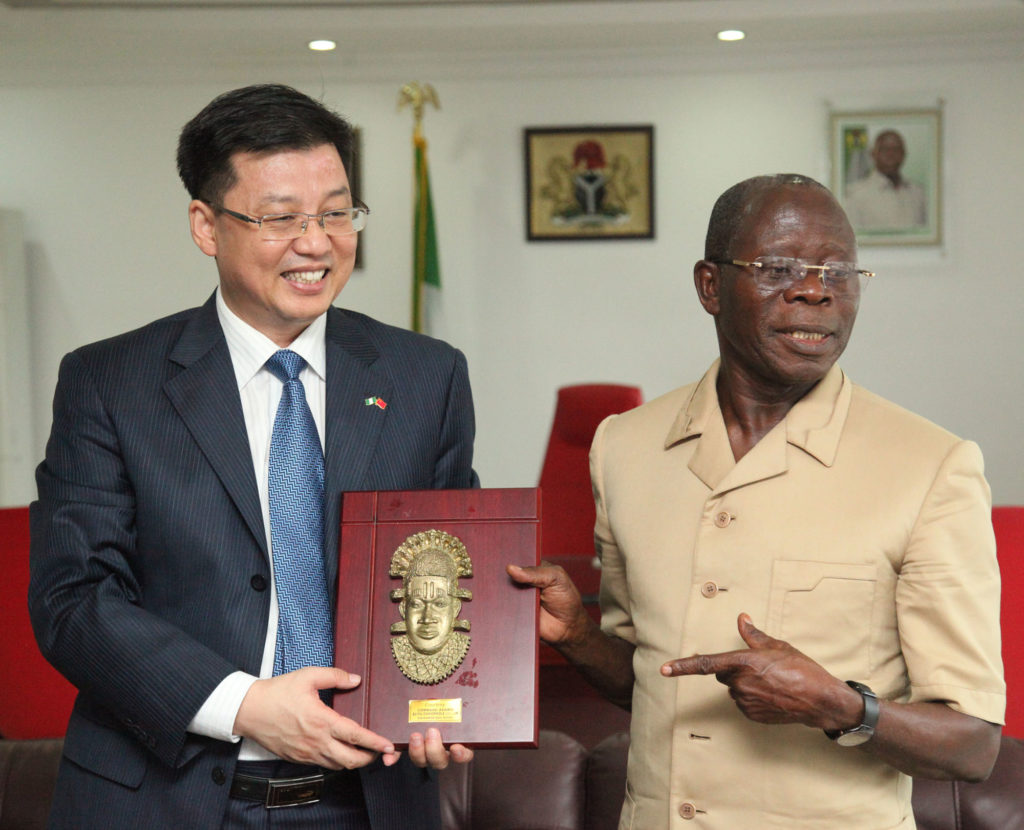 Governor Adams Oshiomhole of Edo State presents a souvenir to Mr Liu Kan, Consul-General, Chinese Consulate during the Consul-General's visit to the Governor in Benin City, Tuesday.