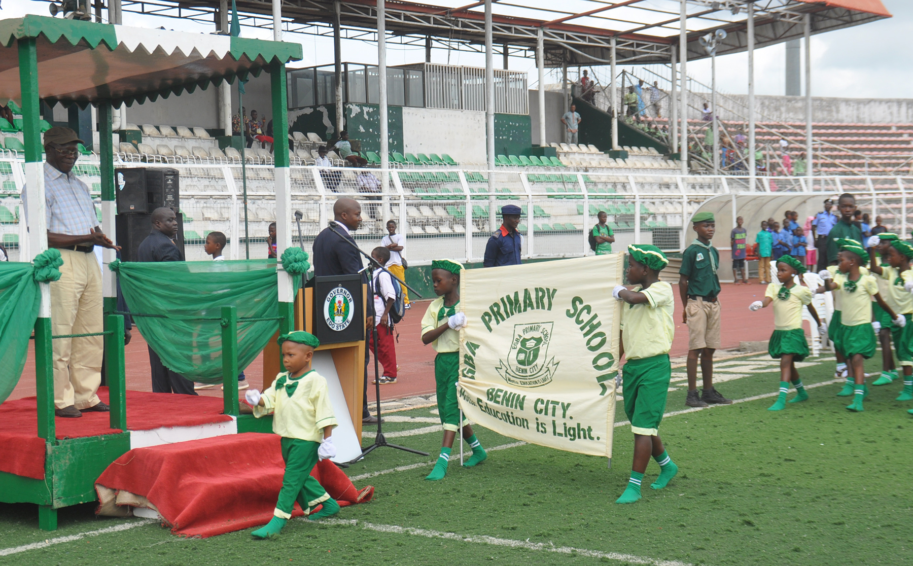 Governor Adams Oshiomhole of Edo State applauds pupils of Egba Primary School, Benin City during a march past at the 2016 Children's Day celebration in Benin City on Friday. 