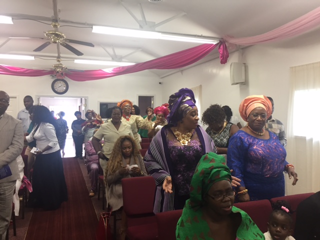 a-cross-section-of-guests-singing-during-the-church-dedication