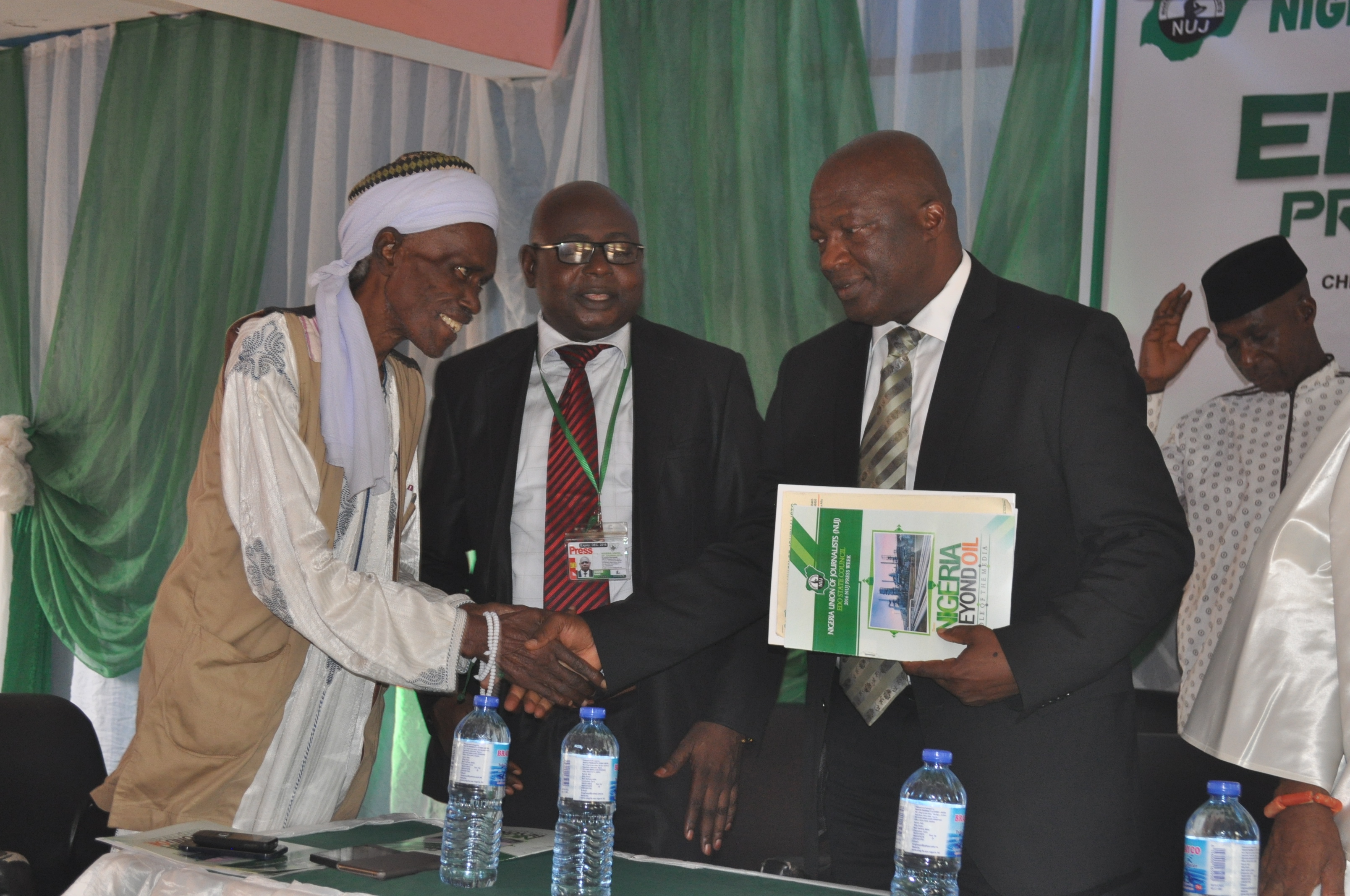 Alh. Usman Abuda exchanging pleasantries with the Secretary to the State Government Osarodion Ogie (Esq) as the NUJ Benin Chairman, Sir Roland Osakue watches on